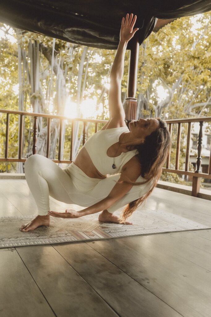 Hannah in a twisting lunge on an open-air deck