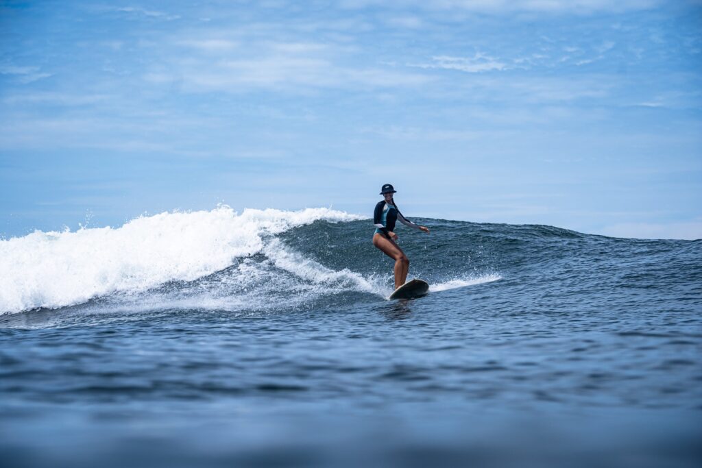 Hannah surfing a wave