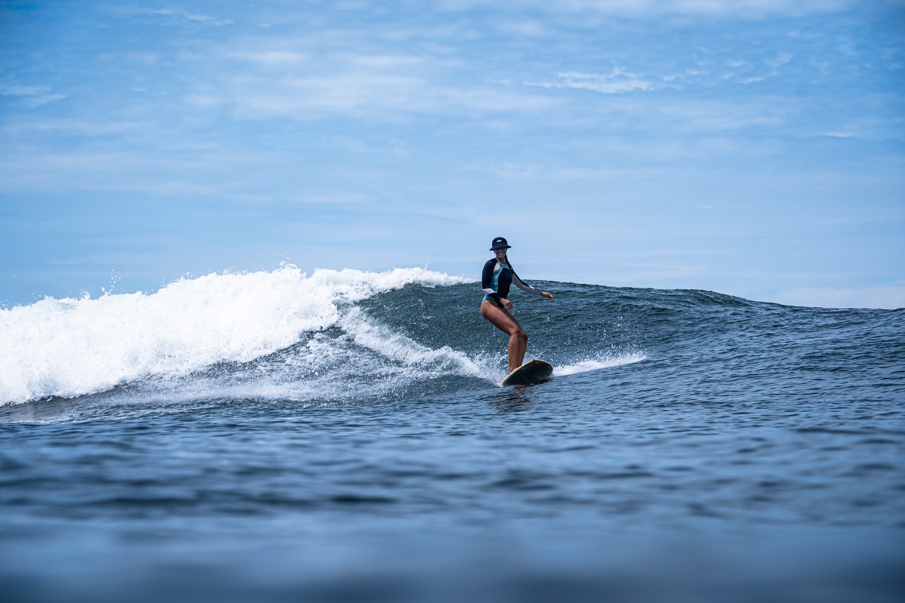 Hannah surfing a wave
