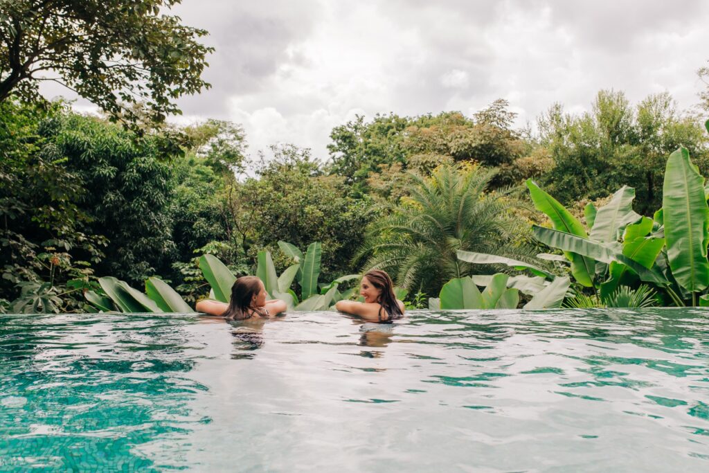 Retreat guests in a pool surrounded by jungle