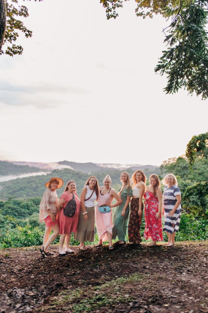 Women on a retreat, standing together above the jungle